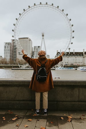 A girl standing next to the London Eye