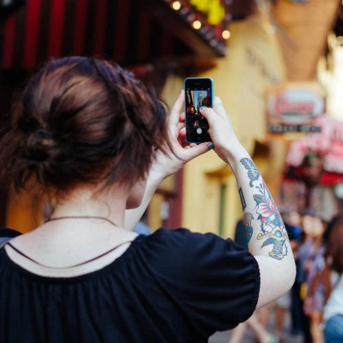 A woman taking photos with her iPhone