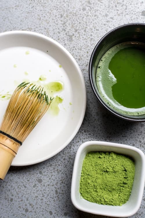 brush with green sauce and bowl of powdered wasabi