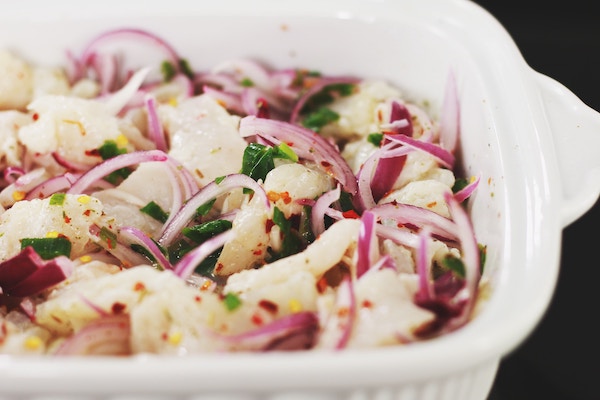 bowl of various vegetables including raw red onions