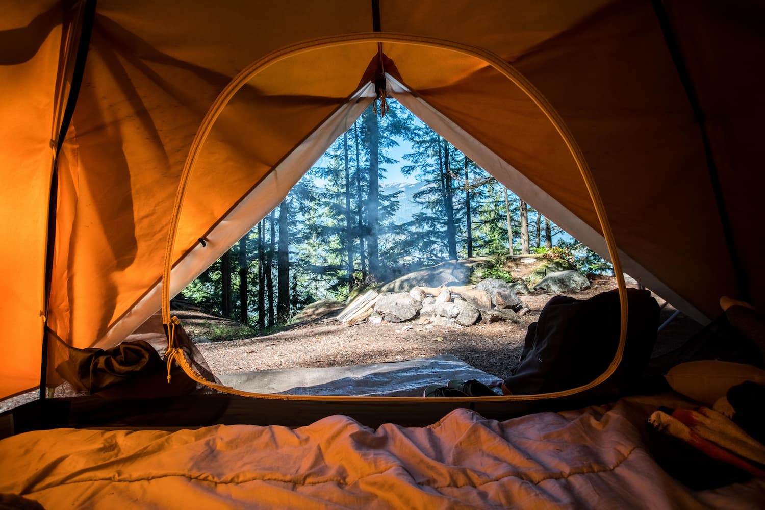 A landscape view of a tent porch looking into the forest