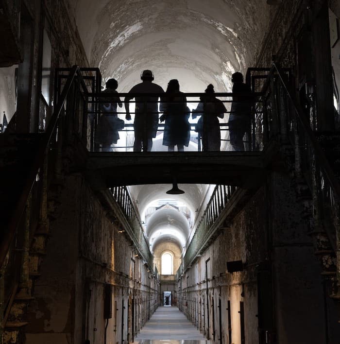 Deserted prison showing its age with peeling wallpaper and dim lighting