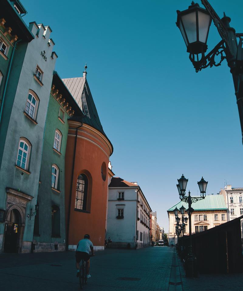 Man cycling through the streets of Krakow