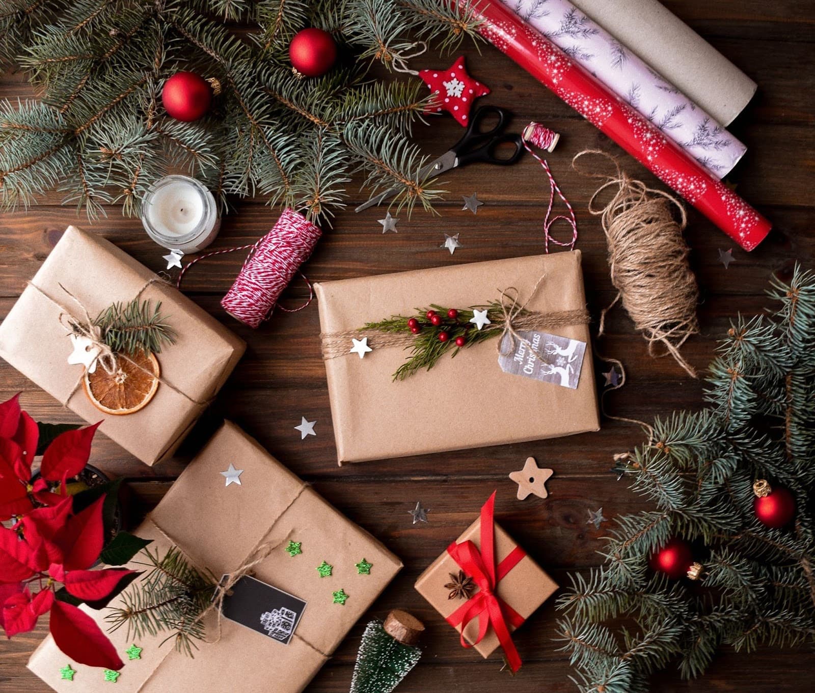 Christmas presents and decorations spread out on table