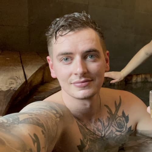 Man enjoying champagne in a hot tub