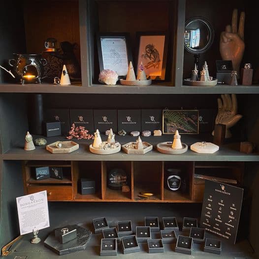 Dark shelves in shop with dozens of pieces of handmade jewelry