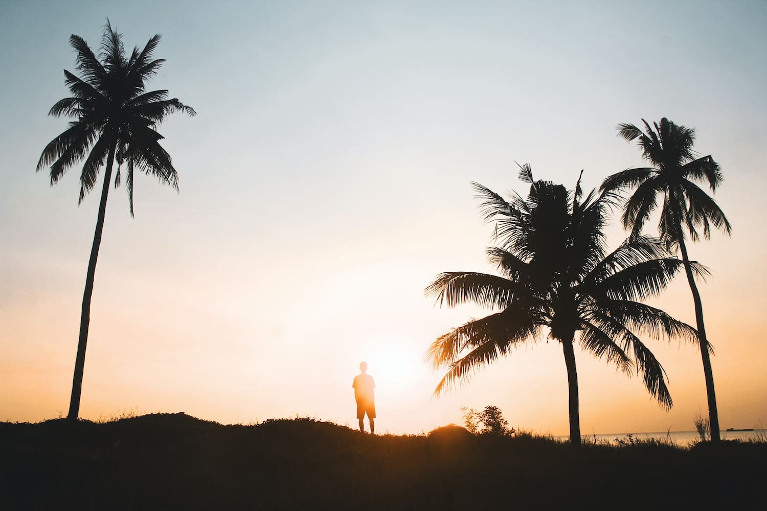 A man standing in the sunset in Indonesia