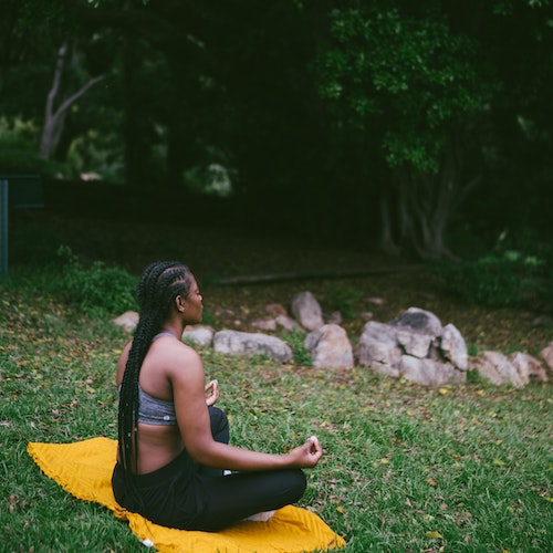 A woman practising yoga in a park