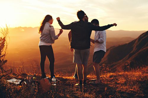 Four People Standing at the top of Grassy Mountain