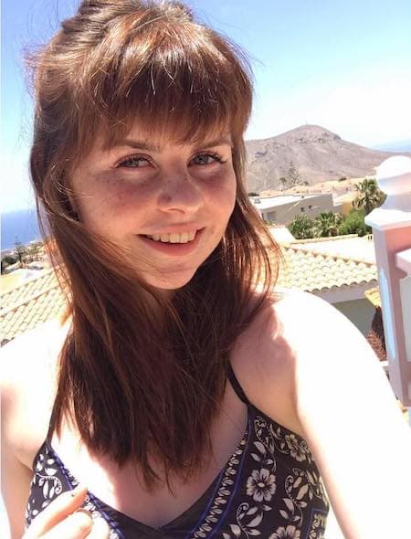 DAYMADE winner, Abbi, posing in front of a mountain in the desert with blue skies in background