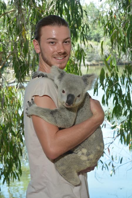 DAYMADE winner, Sam, holding a koala bear in Australia