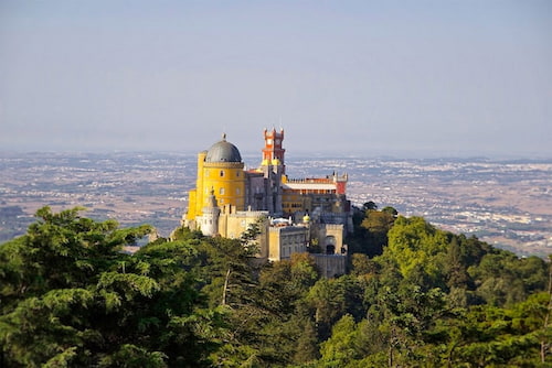 A landscape view of the Pena Palace of Sintra on top of the mountain.