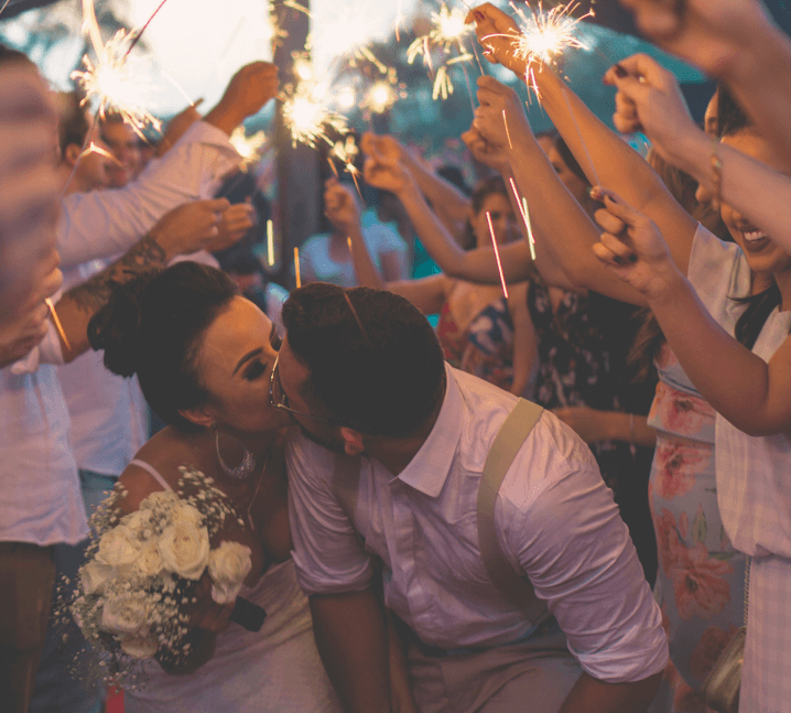 couple kissing with sparklers surrounding them